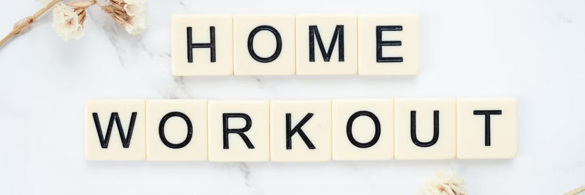 Stylish letter tiles spelling 'Home Workout' on a clean marble background with floral accents.